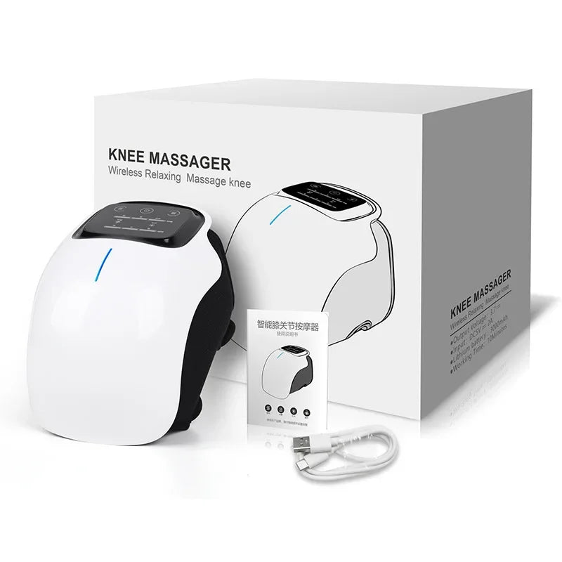 A white knee massager device with a black strap, featuring a control panel with touch buttons, and labels indicating 'KNEE MASSAGER' along with 'HEAT' and 'LIGHT THERAPY'. The product is displayed with Christmas-themed decorations in the background.